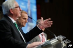 European Commission President Jean-Claude Juncker, left, and European Council President Donald Tusk, center, participate in a media conference at an EU summit in Brussels, Dec. 14, 2018.