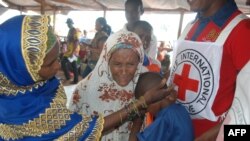 FILE - A 13-year-old Central African Republic refugee cries in the arms of relatives in Lolo, east Cameroon, April 21, 2017.