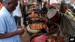 Food prices have shot up in the three countries most affected by Ebola, including Guinea. A customer shops at a market in its capital, Conakry, Aug. 15, 2014.