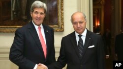 French Foreign Minister Laurent Fabius shakes hands with U.S. Secretary of State John Kerry at the Foreign Affairs Ministry in Paris, Oct. 22, 2013. 