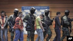 Soldiers escort Julian Zapata Espinosa, fourth right, alleged member of the Los Zetas drug cartel, and other suspects during a presentation for the media in Mexico City, February 23, 2011