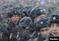 FILE - Russian police officers stand guard during a festive concert marking the second anniversary of Russia's annexation of the Crimea region, in Red Square in central Moscow, Russia, March 18, 2016.