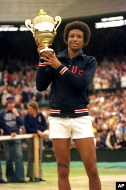 Arthur Ashe holds his Wimbledon trophy cup after defeating fellow American Jimmy Connors in the final match of the men's singles championship at the All England Lawn Tennis Championship in Wimbledon, England, July 5, 1975.