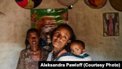 Mebrit Kasua and one of her children at her home in the Tigray Province of northern Ethiopia. Mebrit is a leader in the health development army of women in the Tigray province of northern Ethiopia. The women fight trachoma by providing accurate education