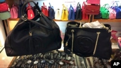 FILE - Counterfeit branded bags appear on display in a room hidden from the public area of a popular shopping mall in Beijing, China, March 11, 2015. The Bank of China is appealing a decision by a New York court to fine it $50,000 a day for withholding information about counterfeiters' bank accounts in China.