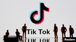 FILE - A 3-D printed figures are seen in front of displayed Tik Tok logo in this picture illustration taken Nov. 7, 2019. 