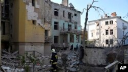Rescuers search for victims in an apartment building destroyed by a Russian missile attack in Lviv, Western Ukraine, Sept. 4, 2024. 