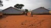 FILE - Refugees walk at the Nyumanzi transit center in Adjumani, Uganda, July 13, 2016. 