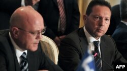 Greece's Finance Minister Yannis Stournaras, (R) listens to Trans Adriatic Pipeline's Managing Director Kjetil Tungland (L) after the signing of an host government agreement in Athens, June 26, 2013.