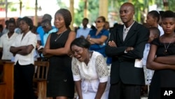Relatives attend a funeral for people who were killed in the past weeks' protest, in Port-au-Prince, Haiti, Nov. 19, 2019. 
