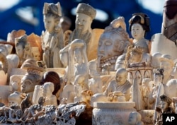 FILE - In a U.S. crackdown,confiscated ivory was stacked for crushing in 2013 at a National Wildlife Property Repository in Commerce City, Colorado.