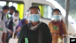 Civic group members arrive at the U.N.-backed war crimes tribunal in Phnom Penh, Cambodia, Aug. 16, 2021.
