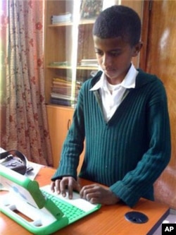 An Ethiopian boy uses the rugged, Internet-connected laptop computer designed and distributed by 'One Laptop Per Child'.