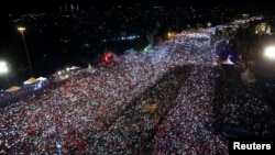 People gather for a ceremony marking the first anniversary of an attempted coup at the Bosporus Bridge in Istanbul, Turkey, July 15, 2017.