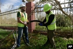 Workers from Liberty Cable restore fiber optic lines three days after the impact of Hurricane Maria in Carolina, Puerto Rico, Sept. 23, 2017.