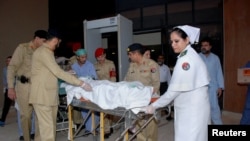 In this photo released by Inter Services Public Relations Department, Pakistani army doctors and medical staff transport 14-year-old schoolgirl Malala Yousufzai, who was shot last Tuesday by the Taliban, to transfer her from a military hospital to the air