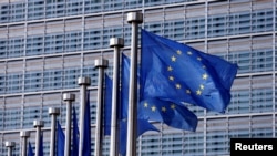 EU flags flutter outside the EU Commission headquarters in Brussels