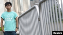 FILE - Hong Kong student leader Joshua Wong poses for a photo, a day before an appeal verdict on charges relating to 2014 pro-democracy "Umbrella Movement," also known as "Occupy Central" protests, in Hong Kong, Aug. 15, 2017.