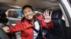 FILE - Philippine journalist Maria Ressa waves to photographers after posting bail outside a court building in Manila, March 29, 2019.