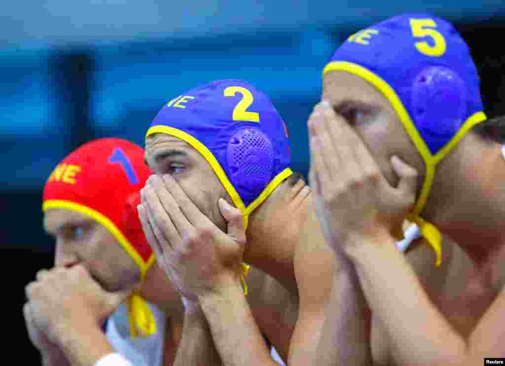 Montenegro's water polo players watch the final seconds of their team's loss to Croatia. 