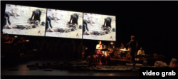 Artists run through a dress rehearsal for "Bangsokol: A Requiem for Cambodia" at the Brooklyn Academy of Music in New York. Behind the performers archival footage plays. (Ye Yuan/VOA)