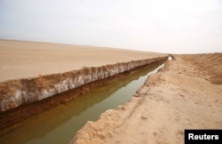 FILE - A general view of a trench that forms part of a barrier along the frontier with Libya is seen in Sabkeht Alyun, Tunisia, Feb. 6, 2016.