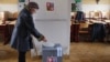 A woman casts her ballot during the country's first-ever direct presidential election to replace the outgoing president Vaclav Klaus, in Prague January 11, 2013.