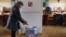 A woman casts her ballot during the country's first-ever direct presidential election to replace the outgoing president Vaclav Klaus, in Prague January 11, 2013.