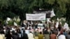 FILE - Nangarhar University students gather as some raise Taliban and Islamic State flags in Jalalabad, Afghanistan, Nov. 8, 2015.