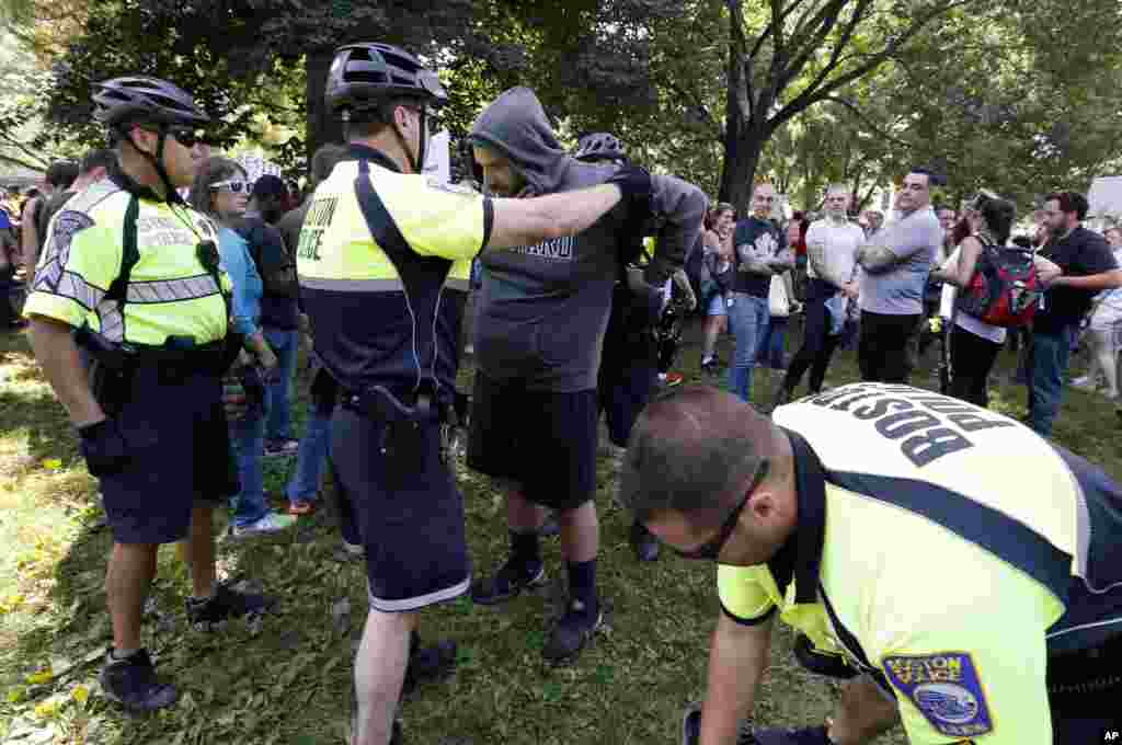 State and city police inspect people arriving for a "Free Speech" rally on Boston Common, Aug. 19, 2017, in Boston. 