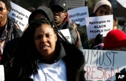 Demonstrators hold signs and chant outside the Governor's Mansion at the Capitol in Richmond, Virginia, Feb. 2, 2019. The protesters are calling for the resignation of Virginia Gov. Ralph Northam after a decades-old photo with a blackface is unearthed in his yearbook.