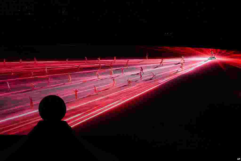 Dancers perform during the opening ceremony in the Olympic Stadium at the 2020 Summer Olympics, July 23, 2021, in Tokyo, Japan.