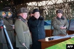 Undated photo released by North Korea's official Korean Central News Agency (KCNA) on Feb. 21, 2016 shows North Korean leader Kim Jong-Un, center, inspecting maneuvers for attack and defense between large combined units of the Korean People's Army (KPA).