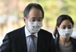 FILE - Then-Japanese Ambassador to South Korea Koji Tomita, left, arrives at the foreign ministry in Seoul, March 6, 2020.