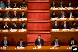 Chinese President Xi Jinping (center) listens during the opening session of the Chinese People's Political Consultative Conference in Beijing's Great Hall of the People, March 3, 2017. The head of China's legislative advisory body, Yu Zhengsheng, said China continues its firm opposition to Taiwan's formal independence and insistence that its leaders accept that the self-governing island is part of China.