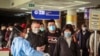 FILE - Passengers arriving on a China Southern Airlines flight from Changsha in China are screened for the new type of coronavirus upon their arrival at the Jomo Kenyatta international airport, in Nairobi, Kenya, Jan. 29, 2020.