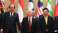 Vietnamese General Secretary Nguyen Phu Trong, center, arrives at venue for the online ASEAN Summit in Hanoi, Vietnam, Nov. 12, 2020.