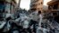 FILE - An Egyptian man makes his way through rubble at the scene of an explosion at a police headquarters building in the Nile Delta city of Mansoura, Egypt, Dec. 24, 2013. 