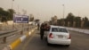 FILE - Iraqi security forces search vehicles at a checkpoint as cars cross into the Green Zone in Baghdad, Iraq, Oct. 5, 2015. The zone houses government buildings and foreign embassies, including that of the United States.