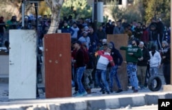 Palestinians clash with Israeli troops during a protest against U.S. President Donald Trump's decision to recognize Jerusalem as the capital of Israel in the West Bank City of Nablus, Dec. 8, 2017.