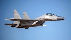 FILE - In this undated photo from the Taiwan Ministry of Defense, a Chinese PLA J-16 fighter jet flies in an undisclosed location. China flew more than 30 military planes toward Taiwan on Oct. 2, 2021, the second large display of force in as many days.