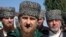 Chechen regional leader Ramzan Kadyrov, center, talks to the media, outside a polling station during parliamentary elections in Chechen town of Tzentoroi, Russia, Sept. 18, 2016.