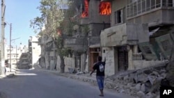 This handout frame grab from video provided by Doctors Without Borders, shows a house on fire in Aleppo, Syria, Oct. 5, 2016. Rebel-held parts of the city have been under sustained aerial assault by Syrian government and Russian forces.