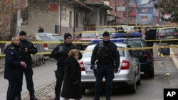 Police officers secure the scene where Kosovo Serb politician Oliver Ivanovic was murdered in front of his office in the northern, Serb-dominated part of Mitrovica, Kosovo, Jan. 16, 2018.