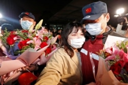 A medical team member hugs a family member at the end of a 14-day quarantine following the team's return from Wuhan, the epicentre of China's coronavirus disease (COVID-19) outbreak, at a hospital in Shanghai, China April 1, 2020. Picture taken…