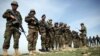 FILE - Afghan National Army soldiers stand in formation following weeks of heavy clashes with Taliban fighters in Dahna-e-Ghori district, Baghlan province, Afghanistan, Mar. 15, 2016.