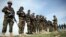 FILE - Afghan National Army soldiers stand in formation following weeks of heavy clashes with Taliban fighters in Dahna-e-Ghori district, Baghlan province, Afghanistan, Mar. 15, 2016.