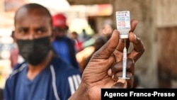 FILE - A health worker prepares a Moderna COVID-19 vaccine dose during a mass vaccination drive in Nairobi, Kenya, Sep. 17, 2021.