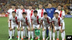 Photo d'illustration: L'équipe chinoise de football pose pour une photo de groupe avant un match entre la Chine et l'Australie à Brisbane, en Australie, le jeudi 22 janvier 2015.