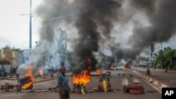 FILE - Anti-government protesters burn tires and barricade roads in the capital Bamako, Mali, July 10, 2020.